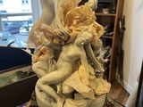 a statue that is sitting on top of a glass table