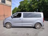 a silver van that is parked in a parking lot