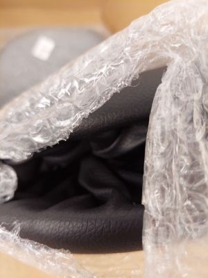 a bag of clothing wrapped in plastic sitting on a table