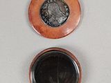 two coins sitting on top of each other on a table