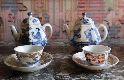 three cups and saucers sitting on a table