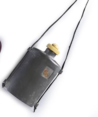 a bottle of wine and a cell phone on a white surface