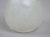 a white glass vase with a design on it