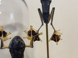 a statue of a frog sitting on top of a table