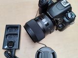 a camera that is sitting on the floor next to a charger