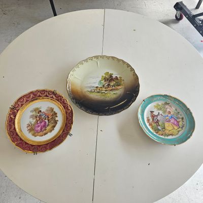 three plates sitting on a white table next to each other