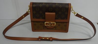 brown and tan louis vuitton cross body bag on a white surface