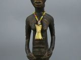 a close up of a statue of a person with a necklace