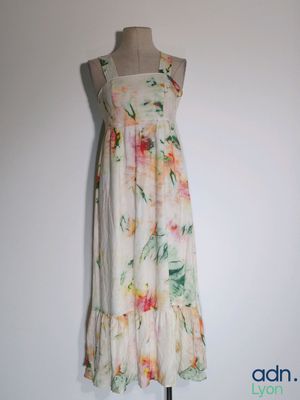 a dress on a mannequin stand against a white wall