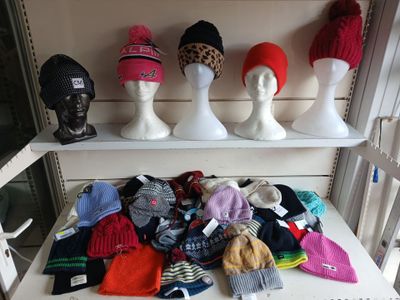 many hats and hats on display on a shelf