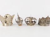 three silver crowns are sitting on top of each other
