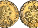 a gold coin with a crown and a cross on it