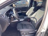 the interior of a car with the door open and the driver ' s seat down