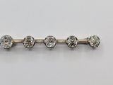 a close up of a row of diamonds on a white surface