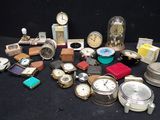 many different types of watches on a black table