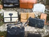 many different types of purses sitting on the steps