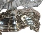 a silver plate with a bird on top of it