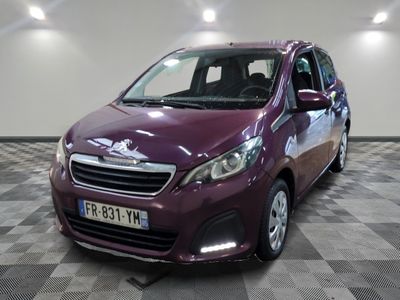 the small purple car is parked in the garage on a checkered floor