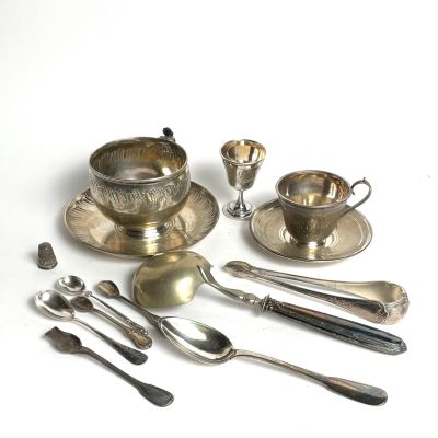 a lot of silver spoons and silverware on the table