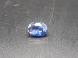a close up of a blue sapphire stone on a black surface