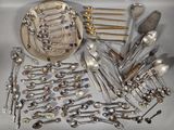 a lot of silver spoons and silverware on the table