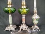 three glass lamps sitting next to each other on a table