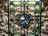 a stained glass window with a clock on it