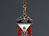 a close up of a medal on a chain on a gray background