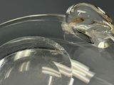 a clear glass bowl with a spoon and a spoon rest on it