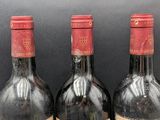 three bottles of wine that are sitting on a table