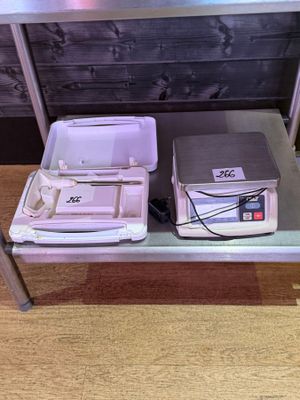 a table with a laptop and a cooler on top of it