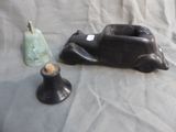 a statue of a dog laying on a bed next to a candle