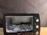 a toaster oven sitting on top of a wooden table