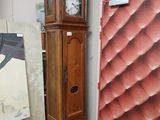 a grandfather clock in the corner of a room next to a painting