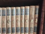 many old books on a shelf in a library