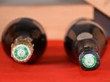 two bottles of beer sitting on a red table