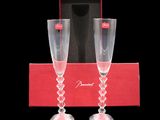pair of champagne flutes in a red box with a black background