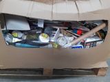 a cardboard box filled with assorted items on a pallet
