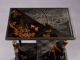 a small table with a black and gold design on it
