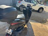 a motor scooter that is parked in front of a building