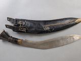 two knives are sitting next to each other on a table