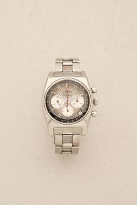 an image of a watch on a white surface with a white background