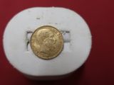 a gold coin sitting on top of a white box