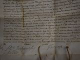 an old document with writing on it sitting on top of a table