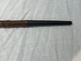 a pipe with a wooden handle on a white sheet