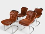 four brown leather lounge chairs with chrome legs