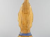 a wooden statue of a woman with a veil on her head