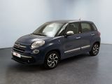 the small blue car is parked in a large room