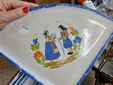 a person holding a plate with a picture of a woman on it