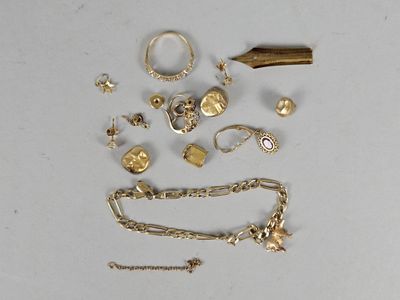 a lot of gold jewelry on a white surface